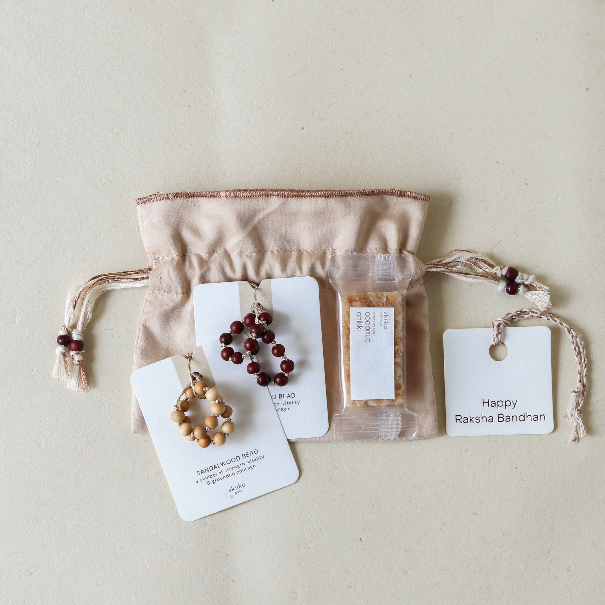 Sacred Sandalwood: Rakhi Set ( 2 Rakhis - 1 Sweet )