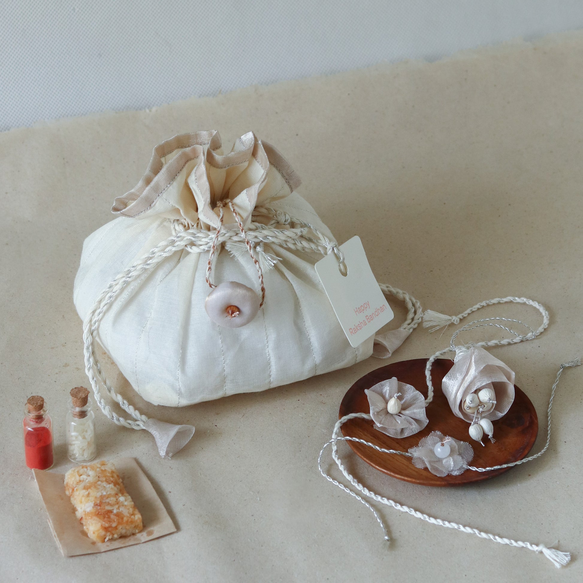 Silver Glow Potli Set (3 Rakhis, 1 Lumba)
