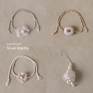 Silver Glow Potli Set (3 Rakhis, 1 Lumba)