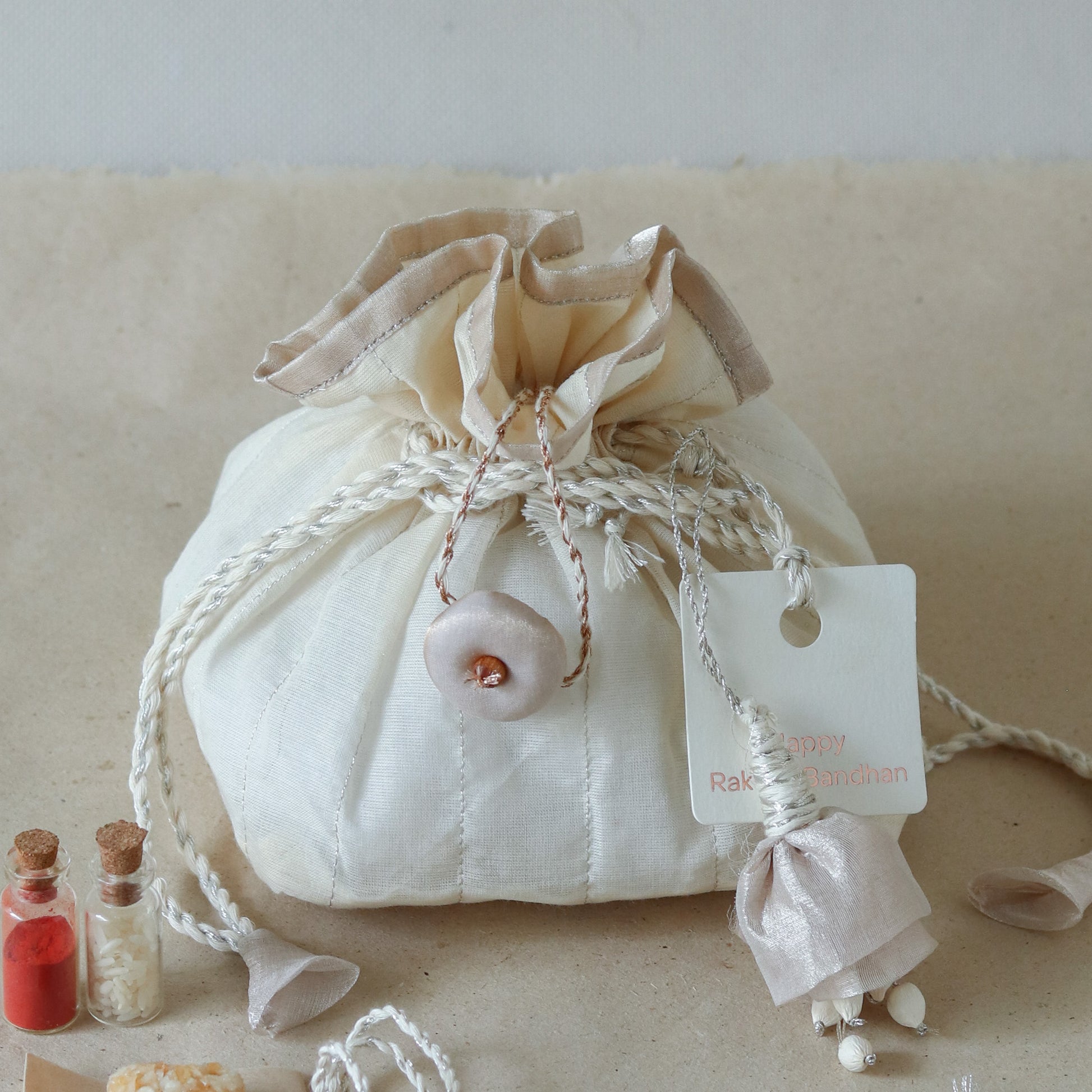Silver Glow Potli Set (3 Rakhis, 1 Lumba)