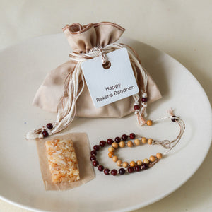 Sacred Sandalwood: Rakhi Set ( 2 Rakhis - 1 Sweet )