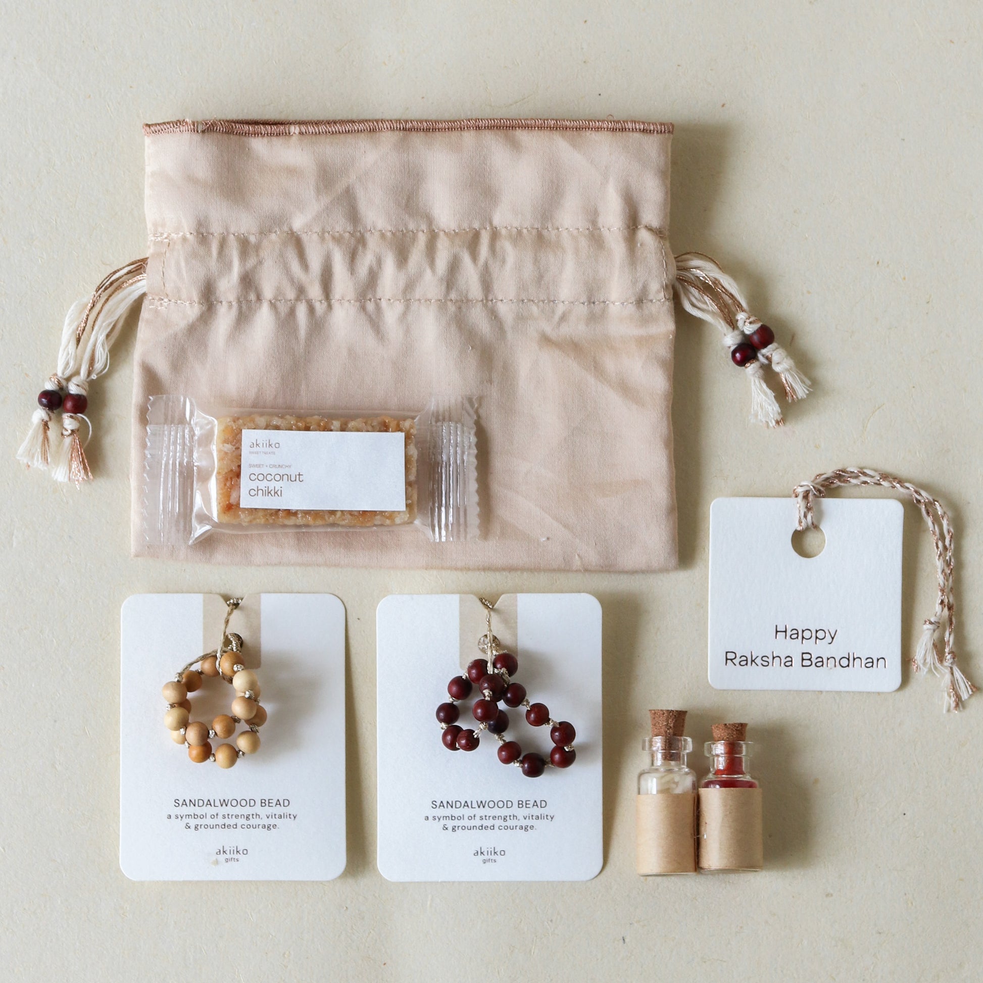 Sacred Sandalwood: Rakhi Set ( 2 Rakhis - 1 Sweet )