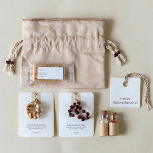 Sacred Sandalwood: Rakhi Set ( 2 Rakhis - 1 Sweet )