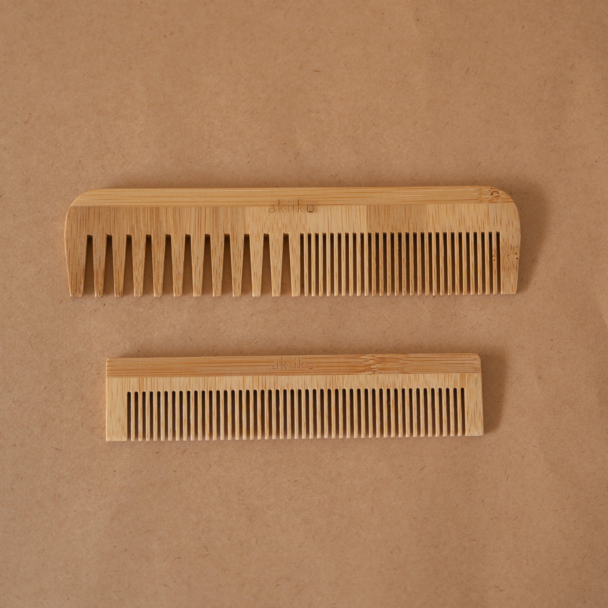 Set of 2 bamboo combs including a pocket comb and a regular comb for gentle detangling and styling.
