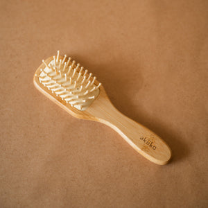 Bamboo Hair Brush with smooth rounded bristles and ergonomic handle for gentle detangling and styling.