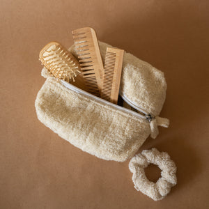 Bamboo Hair Set featuring a bamboo hair brush, pocket comb, regular comb, soft terry scrunchie, all stored in a terry pouch.