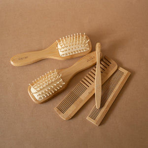 Bamboo Hair Set featuring a bamboo hair brush, pocket comb, regular comb, soft terry scrunchie, all stored in a terry pouch.