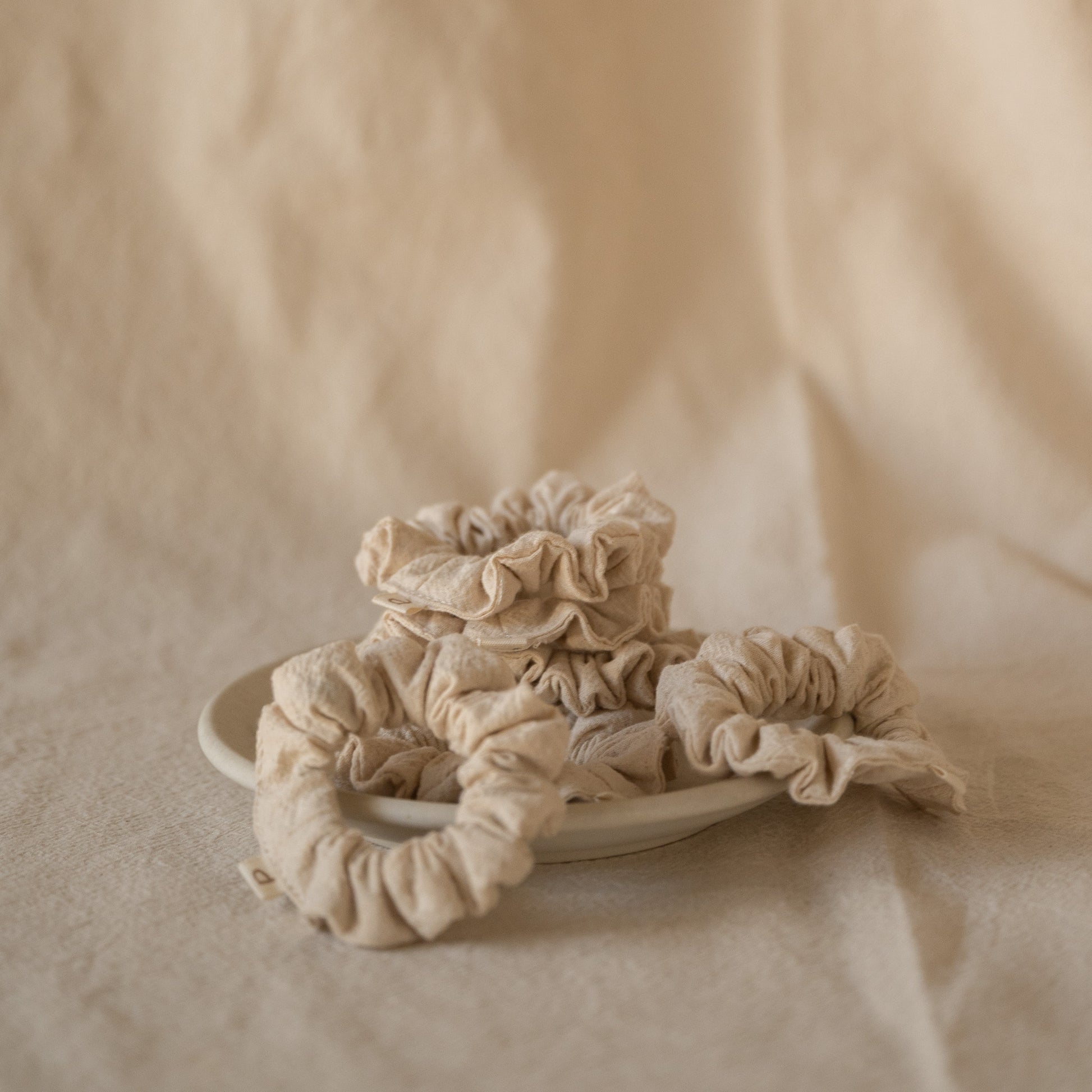 Pack of 6 Chantilly scrunchies made from soft crinkled cotton, packaged in a breathable mesh pouch.
