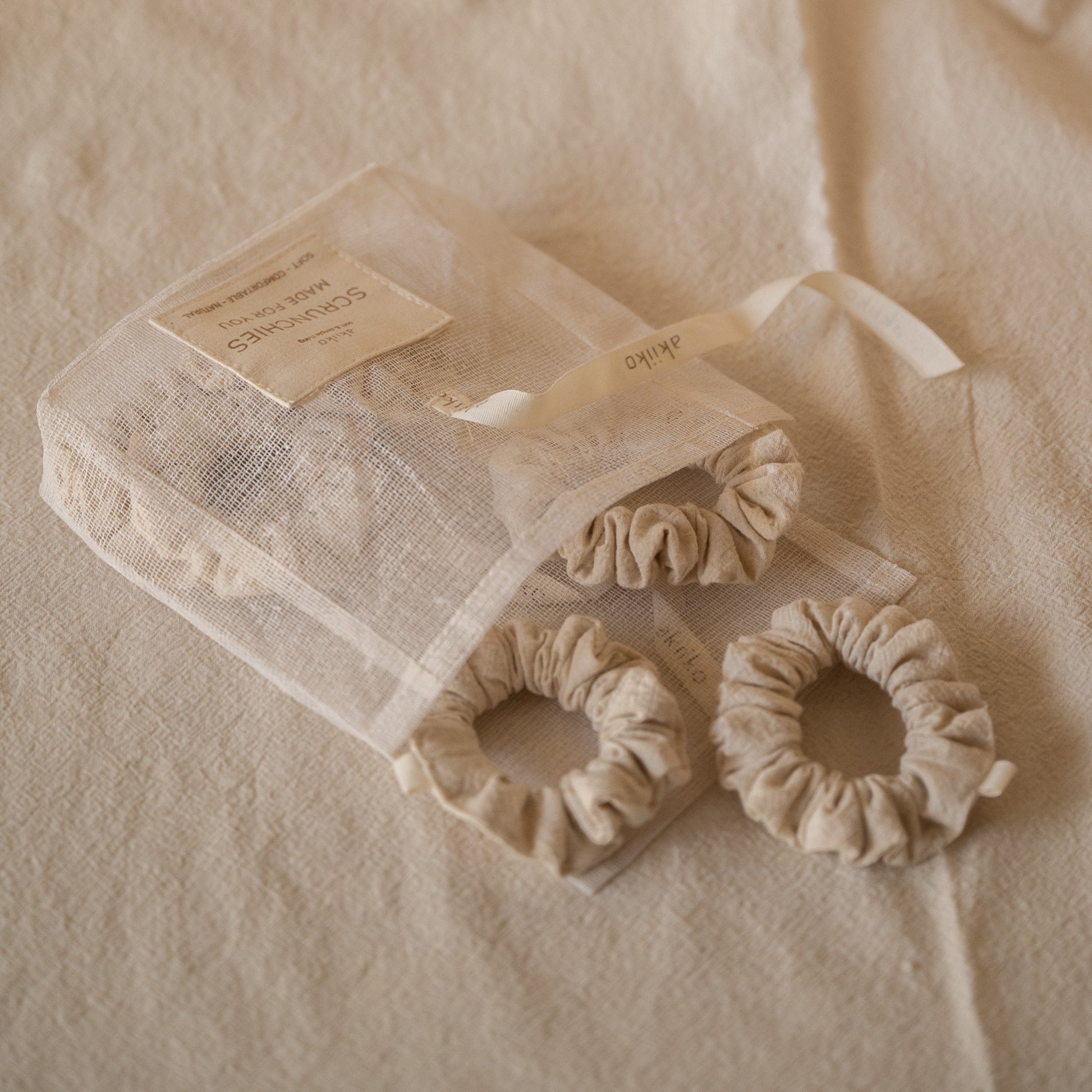 Pack of 6 Chantilly scrunchies made from soft crinkled cotton, packaged in a breathable mesh pouch.