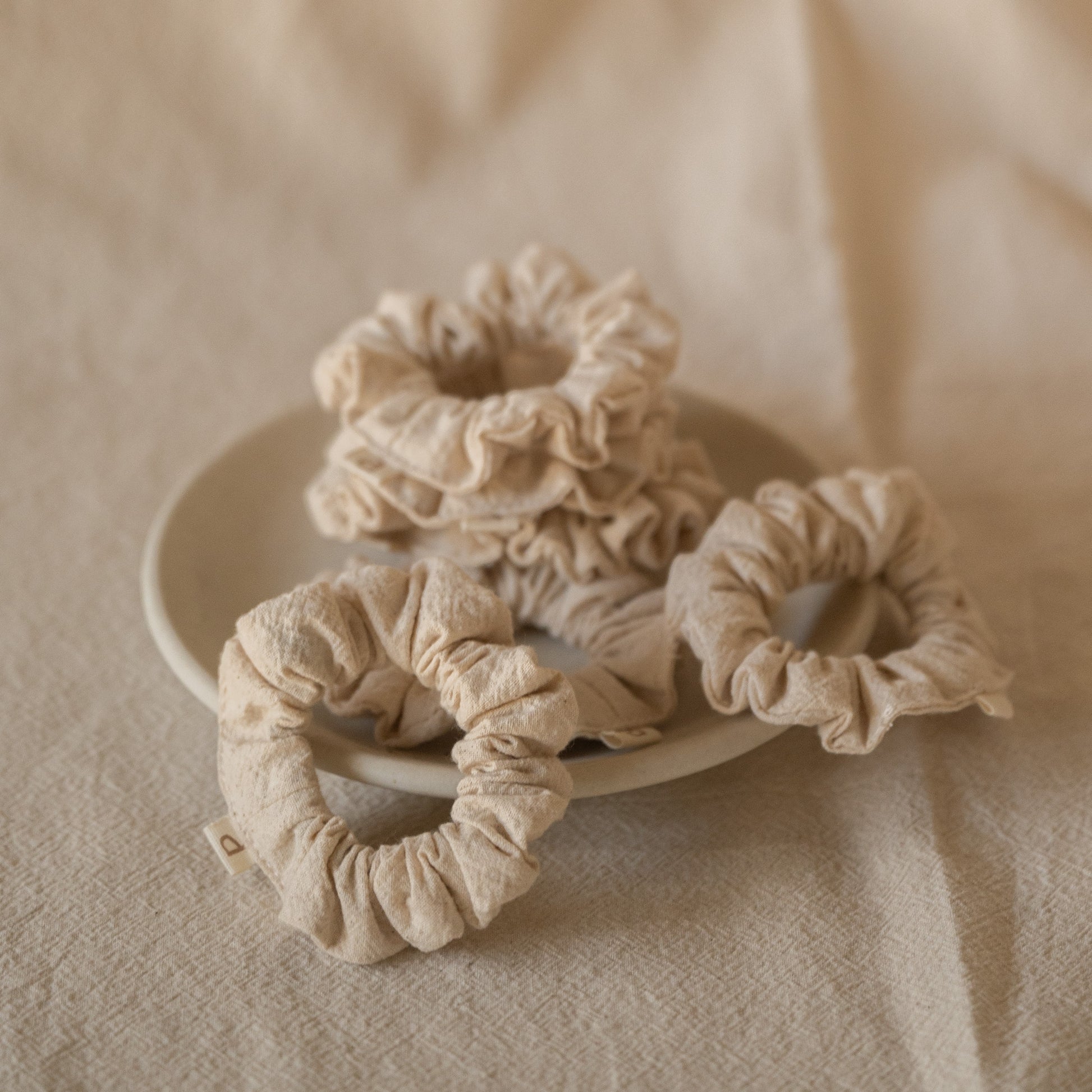 Pack of 6 Chantilly scrunchies made from soft crinkled cotton, packaged in a breathable mesh pouch.