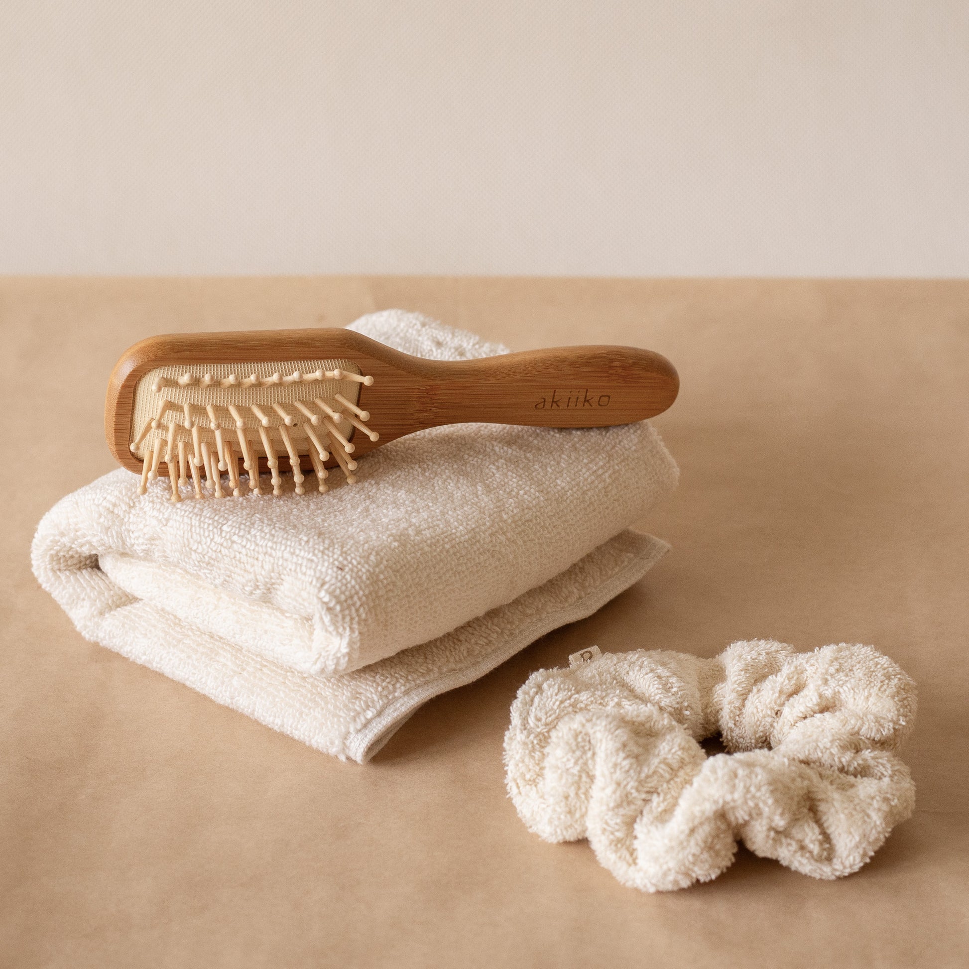 Cloud PM Routine set featuring a soft terry hand towel, plush scrunchie, and eco-conscious bamboo hair brush for nighttime self-care.