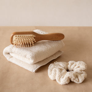 Cloud PM Routine set featuring a soft terry hand towel, plush scrunchie, and eco-conscious bamboo hair brush for nighttime self-care.