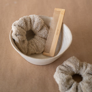Set of three fluffy terry cotton cloud scrunchies in neutral tones, soft and lightweight, with pouch.