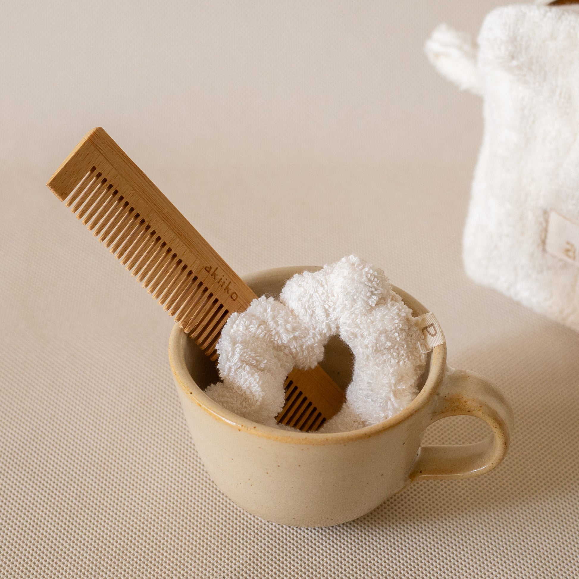 Cloud To-Go Kit (Ivory) featuring a mini cloud cube pouch, soft cloud scrunchie, and bamboo pocket comb for on-the-go organization.