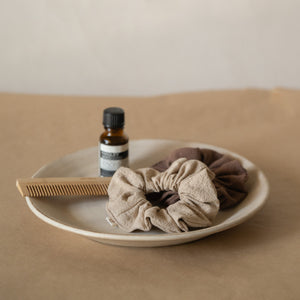 Pack of 3 crinkle cotton scrunchies in natural, wheat, and espresso tones, packaged in a mesh pouch.