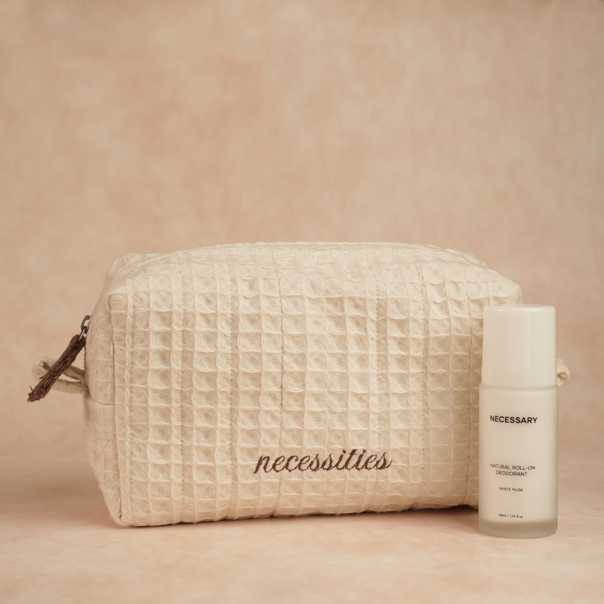 Daily Deo Kit featuring Necessary White Musk aluminum-free deodorant and a waffle-woven cotton pouch with espresso embroidery and zipper accents.