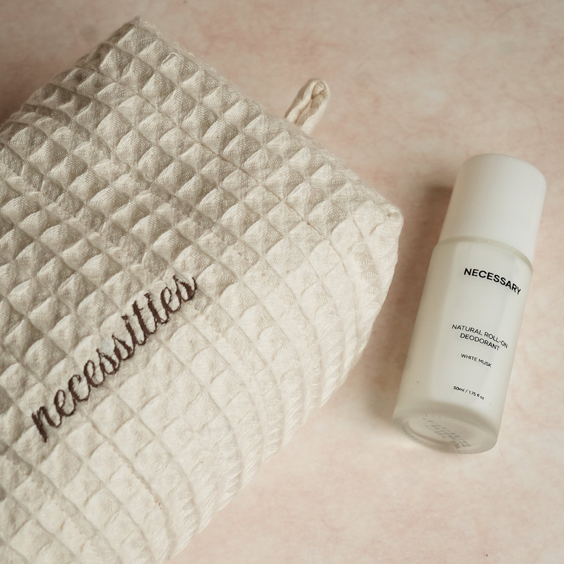 Daily Deo Kit featuring Necessary White Musk aluminum-free deodorant and a waffle-woven cotton pouch with espresso embroidery and zipper accents.
