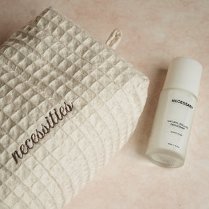 Daily Deo Kit featuring Necessary White Musk aluminum-free deodorant and a waffle-woven cotton pouch with espresso embroidery and zipper accents.