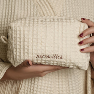 Daily Deo Kit featuring Necessary White Musk aluminum-free deodorant and a waffle-woven cotton pouch with espresso embroidery and zipper accents.