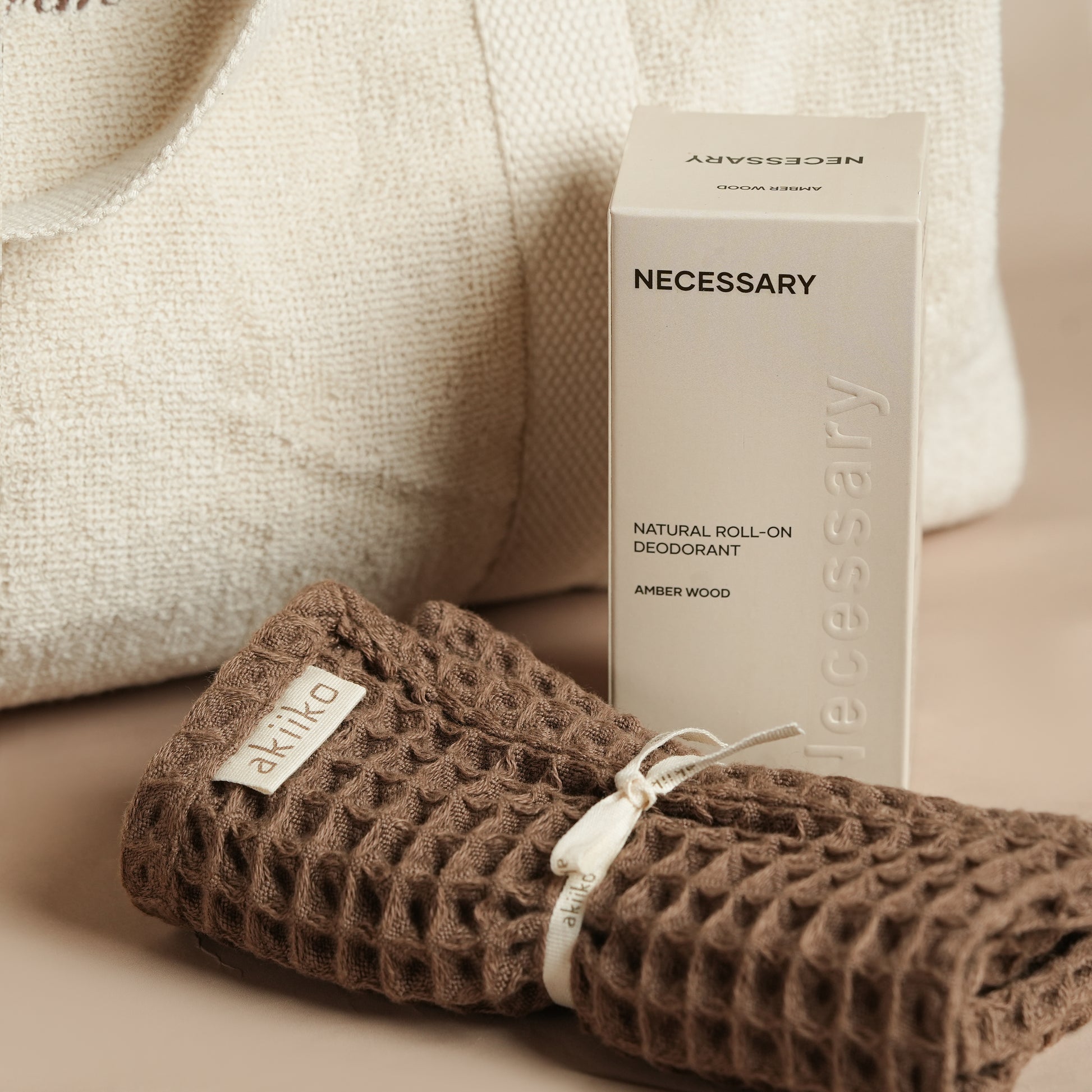 Fresh Companion Set featuring a soft terry cotton duffle with espresso embroidery and charm, matching espresso waffle face towel, and Necessary Amber Wood aluminum-free deodorant.