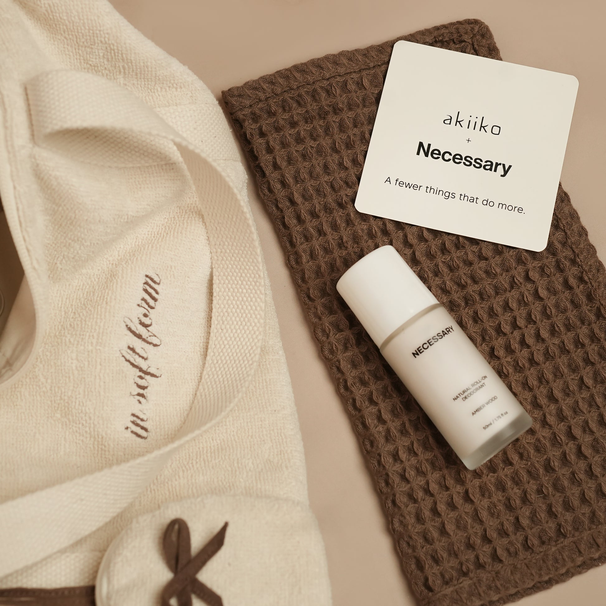 Fresh Companion Set featuring a soft terry cotton duffle with espresso embroidery and charm, matching espresso waffle face towel, and Necessary Amber Wood aluminum-free deodorant.