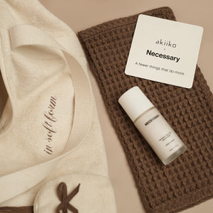 Fresh Companion Set featuring a soft terry cotton duffle with espresso embroidery and charm, matching espresso waffle face towel, and Necessary Amber Wood aluminum-free deodorant.