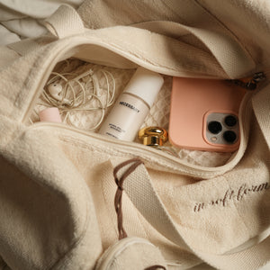 Fresh Companion Set featuring a soft terry cotton duffle with espresso embroidery and charm, matching espresso waffle face towel, and Necessary Amber Wood aluminum-free deodorant.