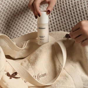 Fresh Companion Set featuring a soft terry cotton duffle with espresso embroidery and charm, matching espresso waffle face towel, and Necessary Amber Wood aluminum-free deodorant.