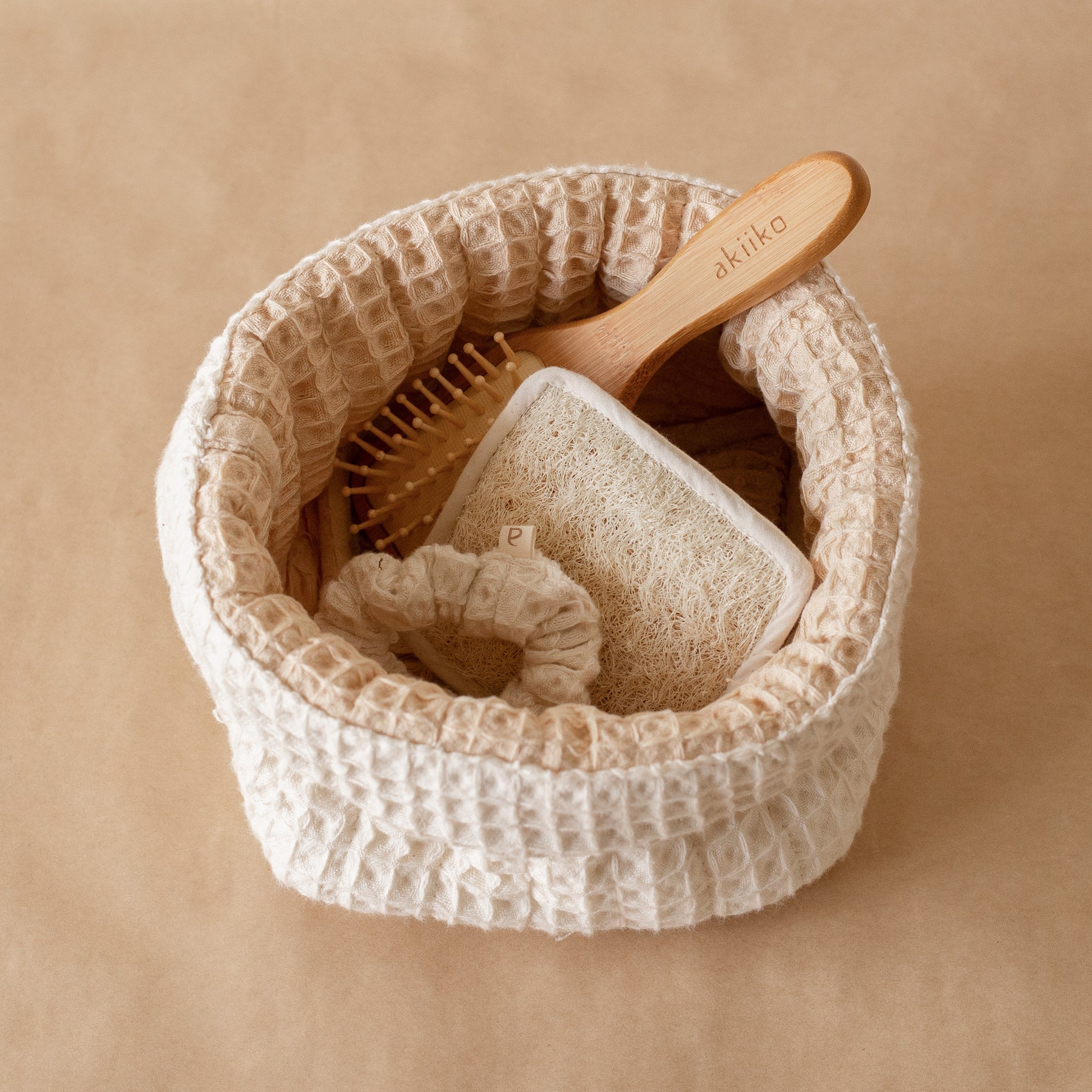 Honey Milk Waffle Care Kit featuring a small waffle storage basket, waffle scrubber, bamboo hair brush, and waffle scrunchie for a soothing daily ritual.