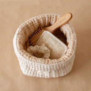 Honey Milk Waffle Care Kit featuring a small waffle storage basket, waffle scrubber, bamboo hair brush, and waffle scrunchie for a soothing daily ritual.