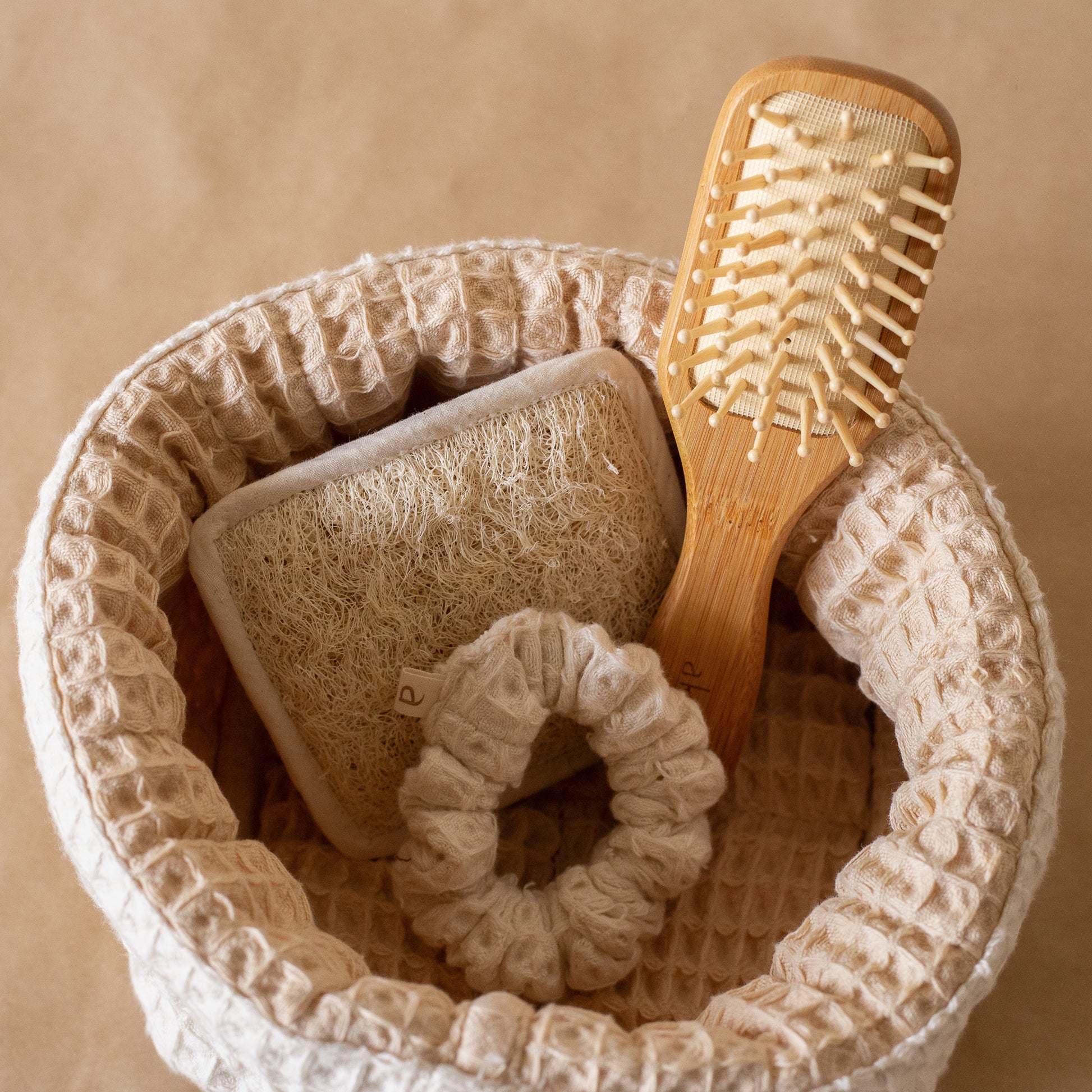 Honey Milk Waffle Care Kit featuring a small waffle storage basket, waffle scrubber, bamboo hair brush, and waffle scrunchie for a soothing daily ritual.