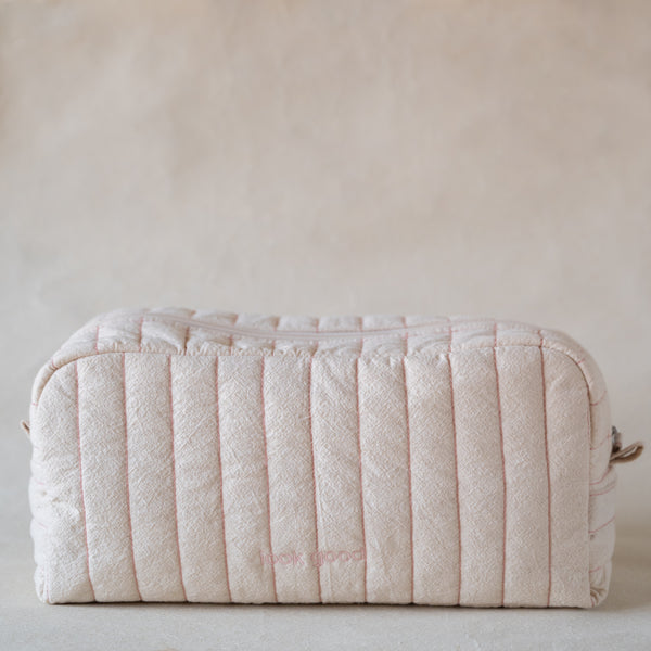Long curved crinkle-cotton pouch with “look good” pink embroidery, front view
