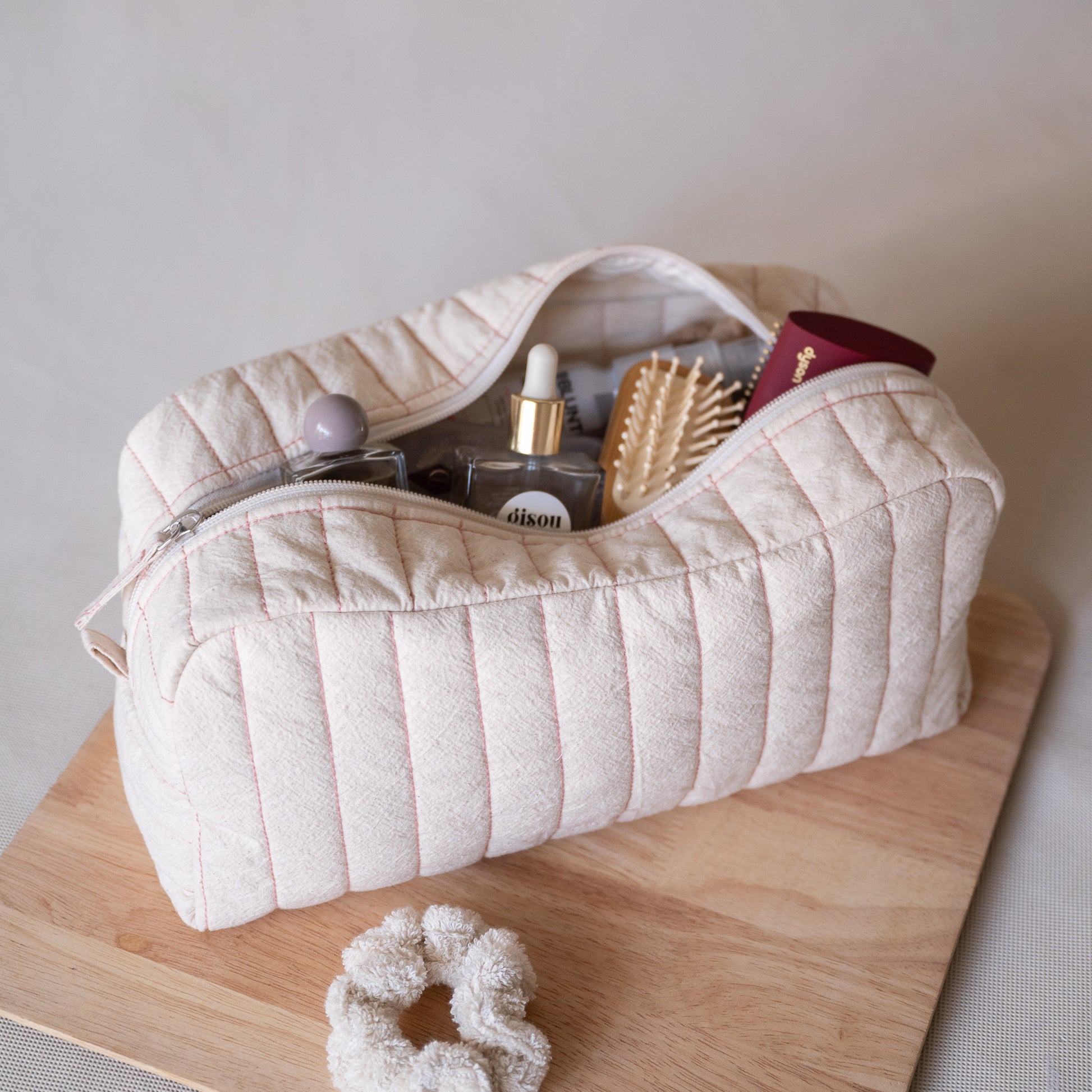Long curved crinkle-cotton pouch with “look good” pink embroidery, open view