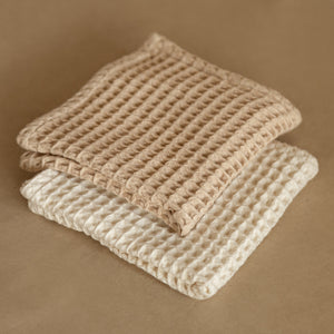 Set of four pique waffle cotton face towels, 30x30 cm, soft, plush, and absorbent with textured weave.