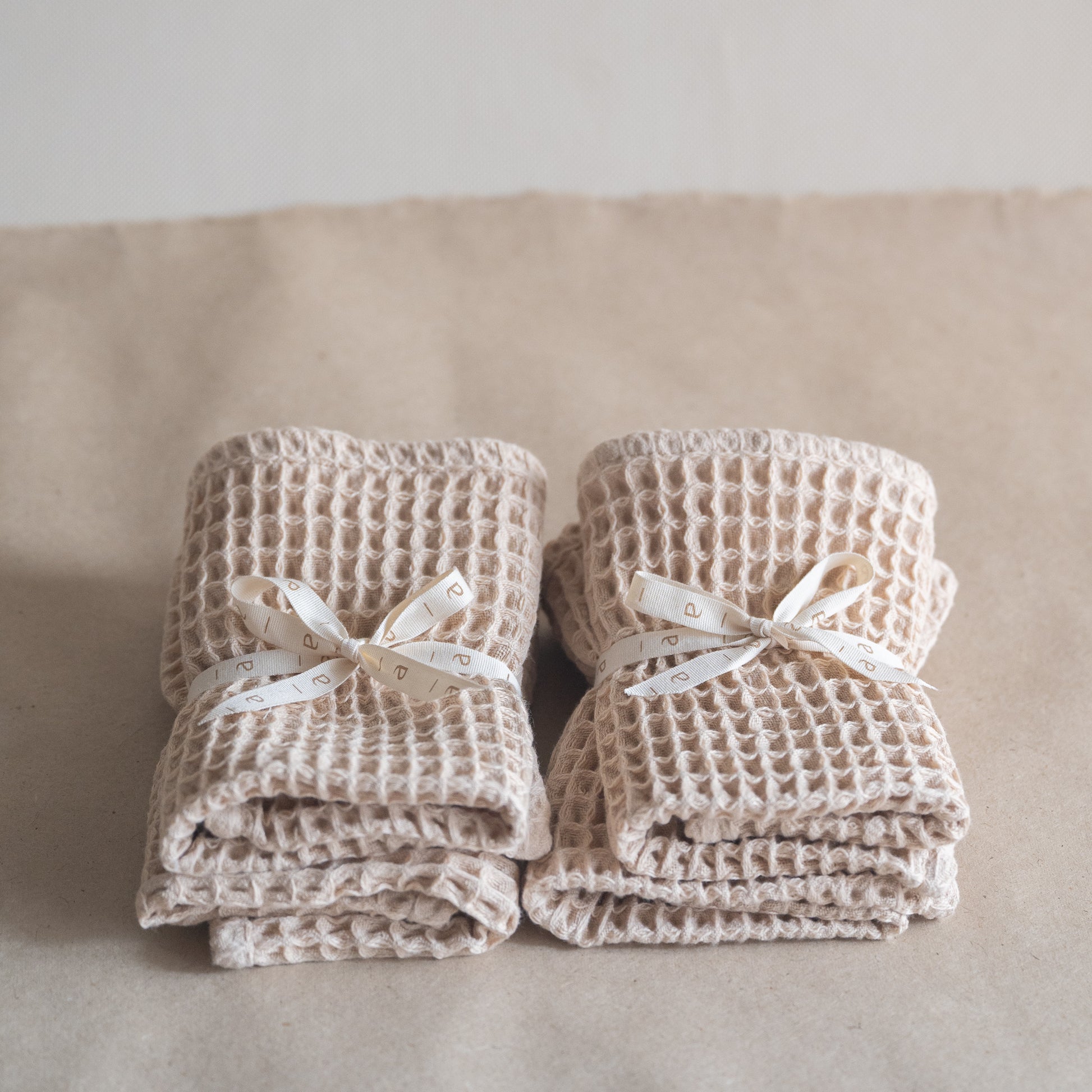 Set of four pique waffle cotton face towels, 30x30 cm, soft, plush, and absorbent with textured weave.