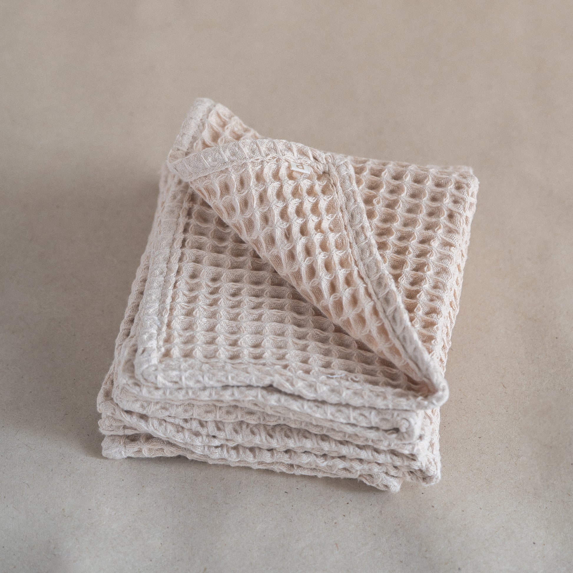 Set of four pique waffle cotton face towels, 30x30 cm, soft, plush, and absorbent with textured weave.