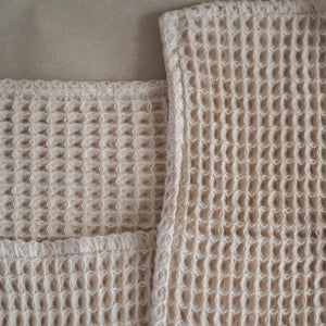 Set of four pique waffle cotton face towels, 30x30 cm, soft, plush, and absorbent with textured weave.