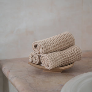 Set of four pique waffle cotton face towels, 30x30 cm, soft, plush, and absorbent with textured weave.