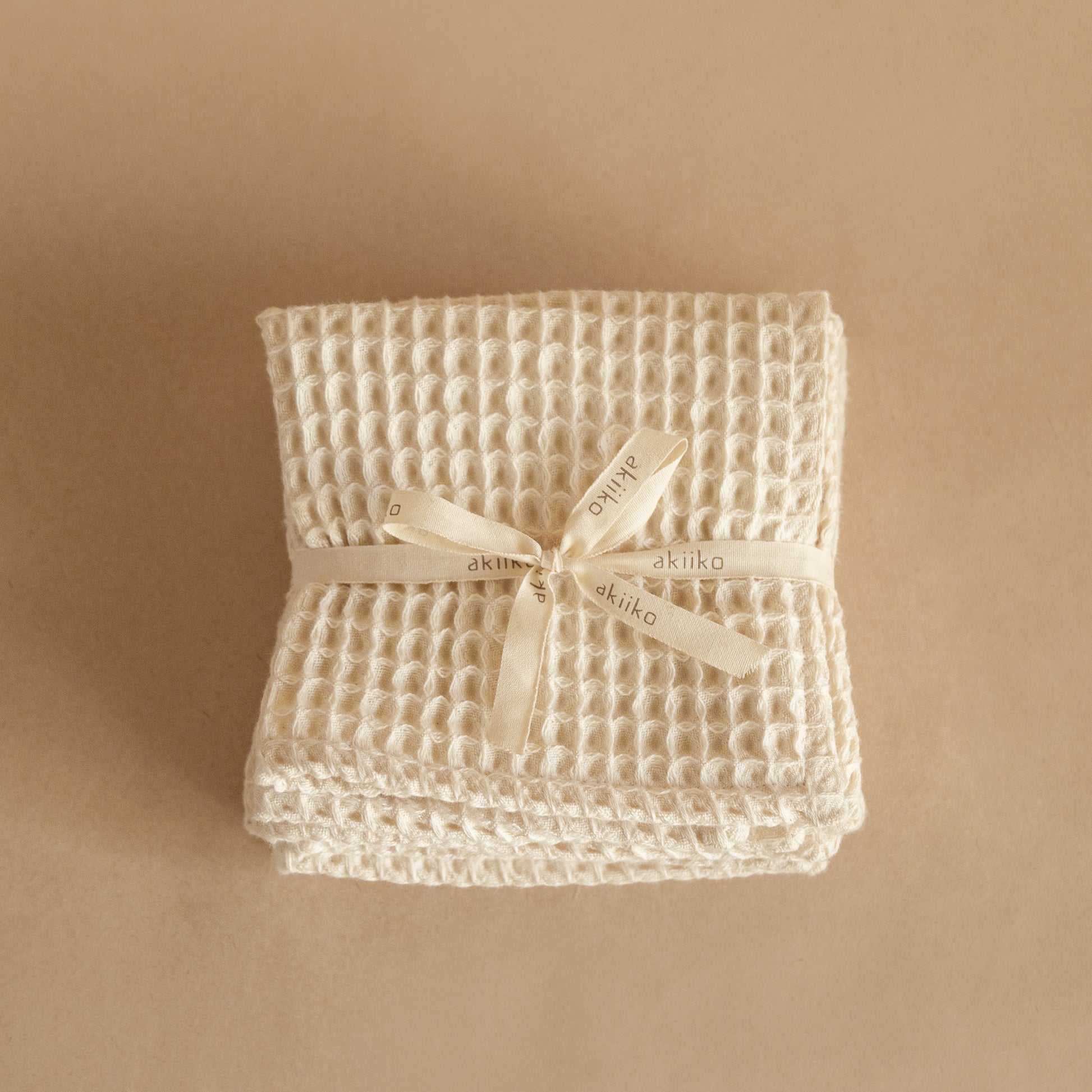 Set of four pique waffle cotton face towels, 30x30 cm, soft, plush, and absorbent with textured weave.