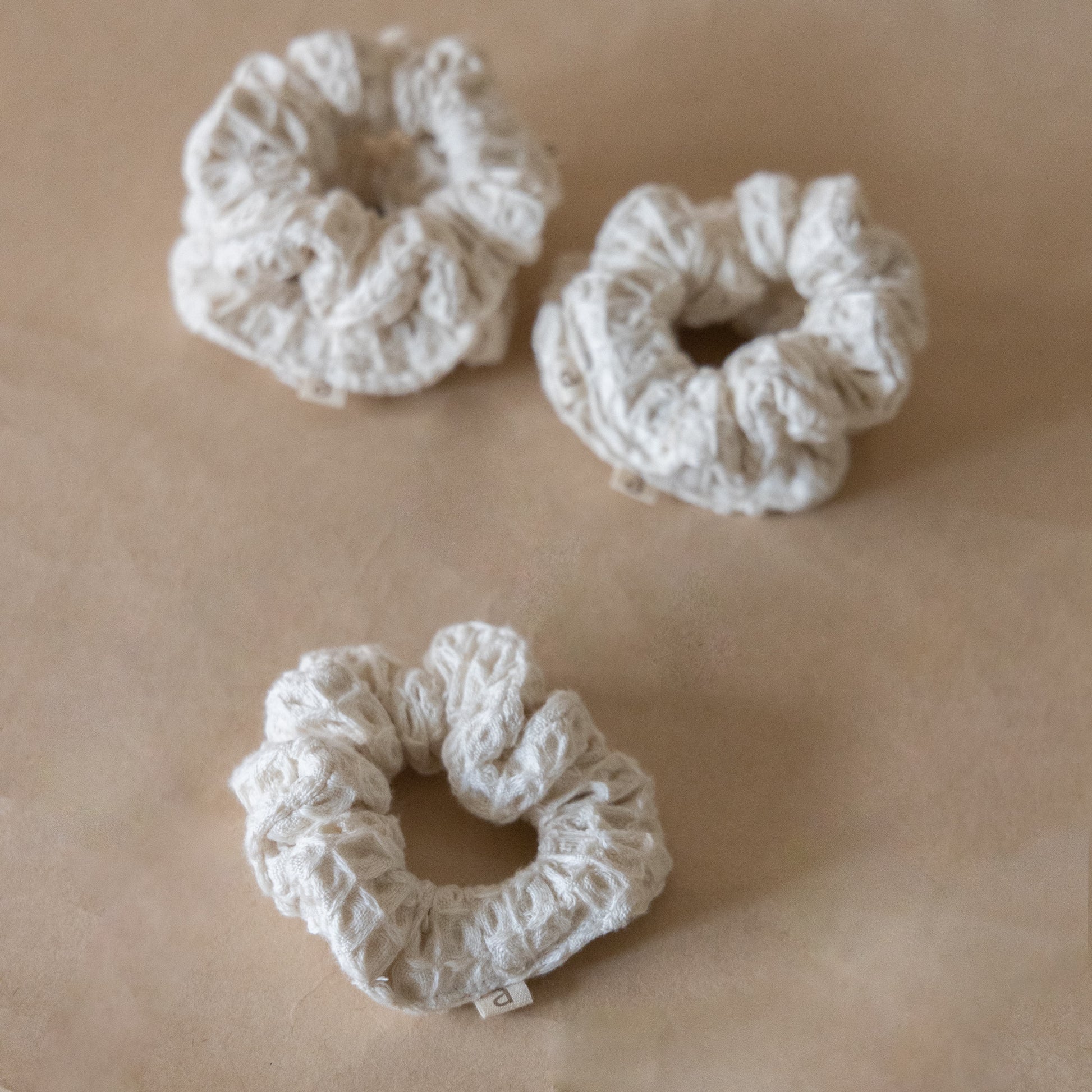 Pack of five wheat-colored pique waffle skinny scrunchies, made from soft stretchy cotton, perfect for hair or wrist accessory.
