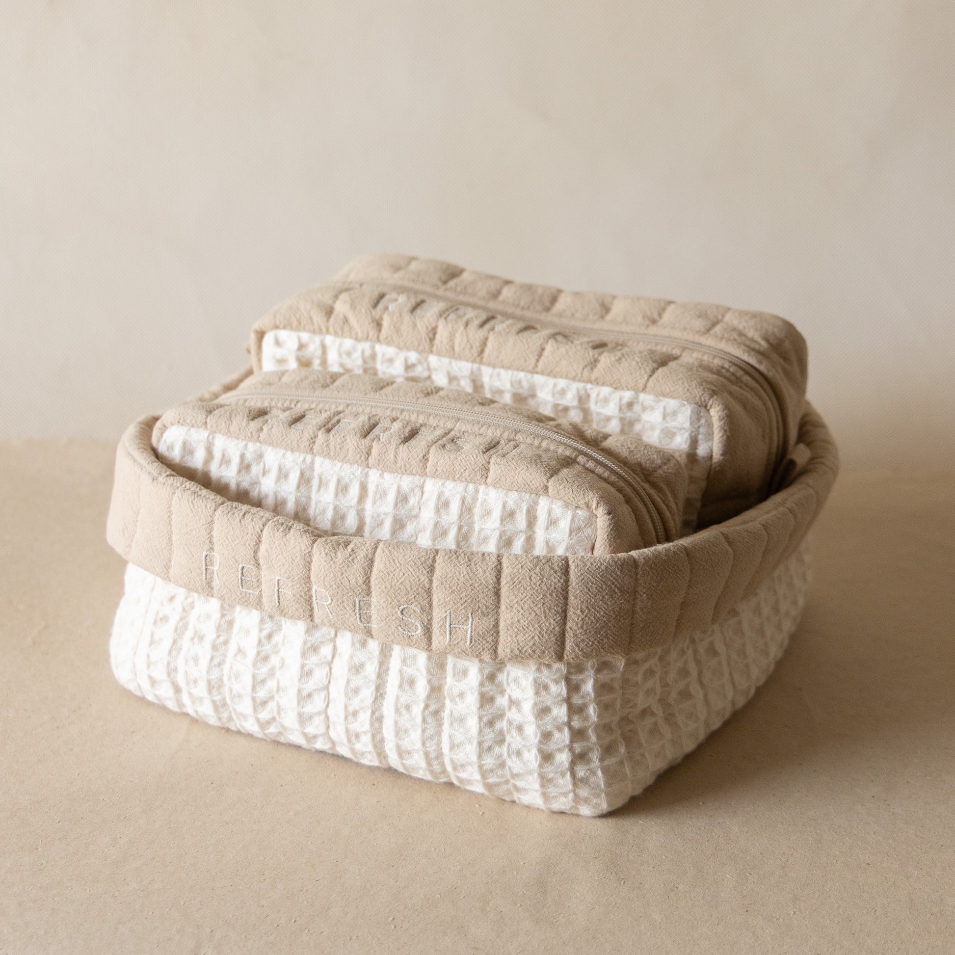 Refresh Waffle Pouch Set featuring a large waffle-crinkle foldover basket embroidered with “REFRESH” and matching small and medium waffle pouches in wheat and natural shades.