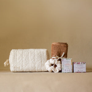 Rise Softly AM Skincare Routine set featuring vitamin C serum, aloe vera gel, ivory terry pouch and scrunchie, and a pecan soft terry face towel.