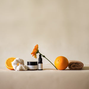 Rise Softly AM Skincare Routine set featuring vitamin C serum, aloe vera gel, ivory terry pouch and scrunchie, and a pecan soft terry face towel.