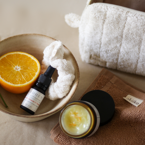 Rise Softly AM Skincare Routine set featuring vitamin C serum, aloe vera gel, ivory terry pouch and scrunchie, and a pecan soft terry face towel.