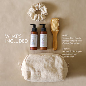 Roots & Rituals Hair Care Set featuring Ayurvedic shampoo and conditioner, bamboo hair brush, crinkle scrunchie, and curl pouch.