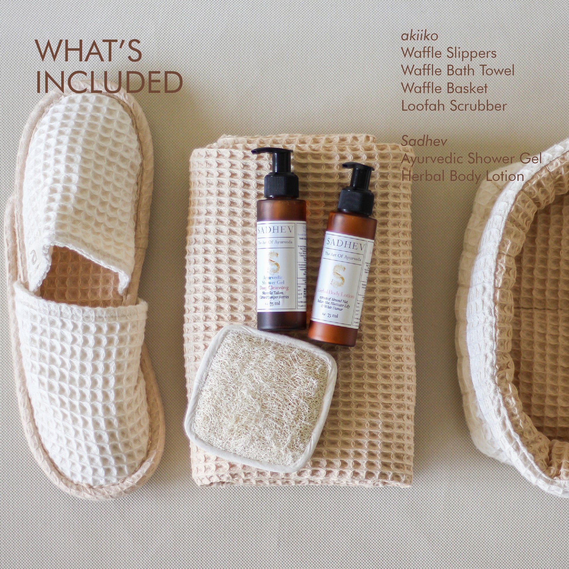 Soak & Soothe Bath Kit featuring Ayurvedic shower gel, body lotion, waffle luffa scrubber, latte waffle bath towel, cozy bath slippers, and a waffle storage basket.