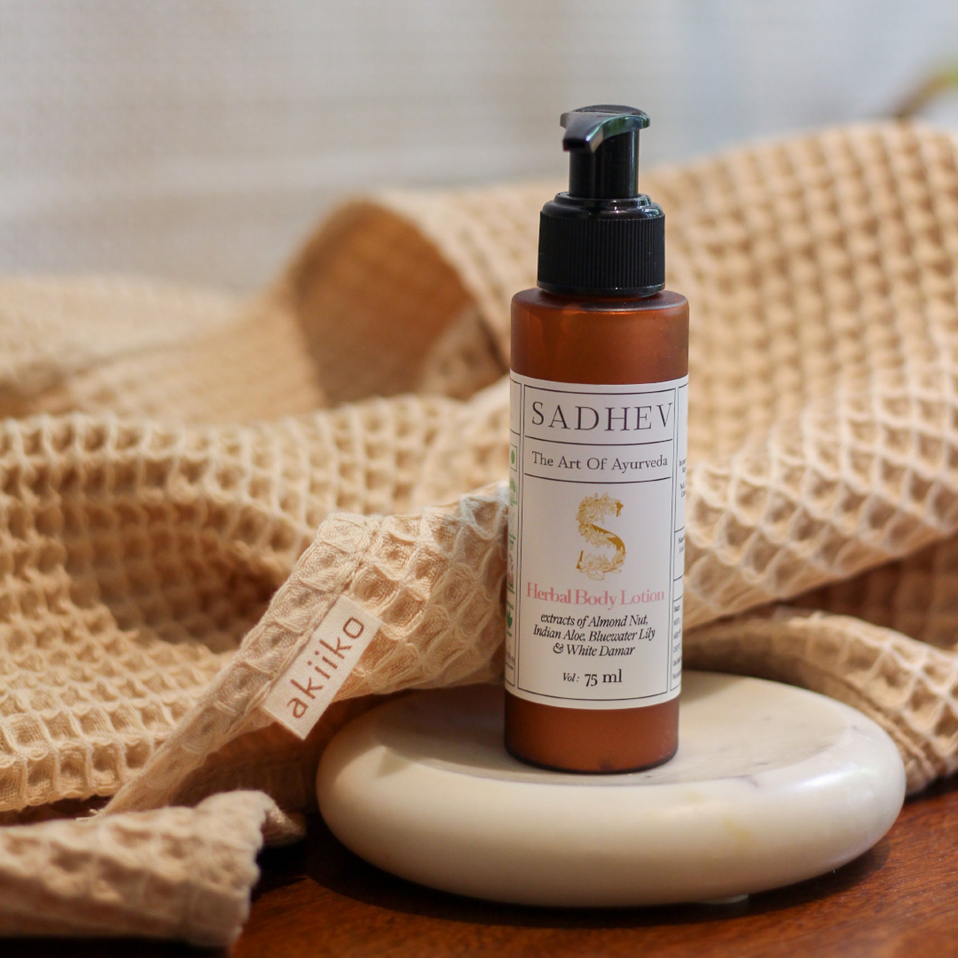 Soak & Soothe Bath Kit featuring Ayurvedic shower gel, body lotion, waffle luffa scrubber, latte waffle bath towel, cozy bath slippers, and a waffle storage basket.