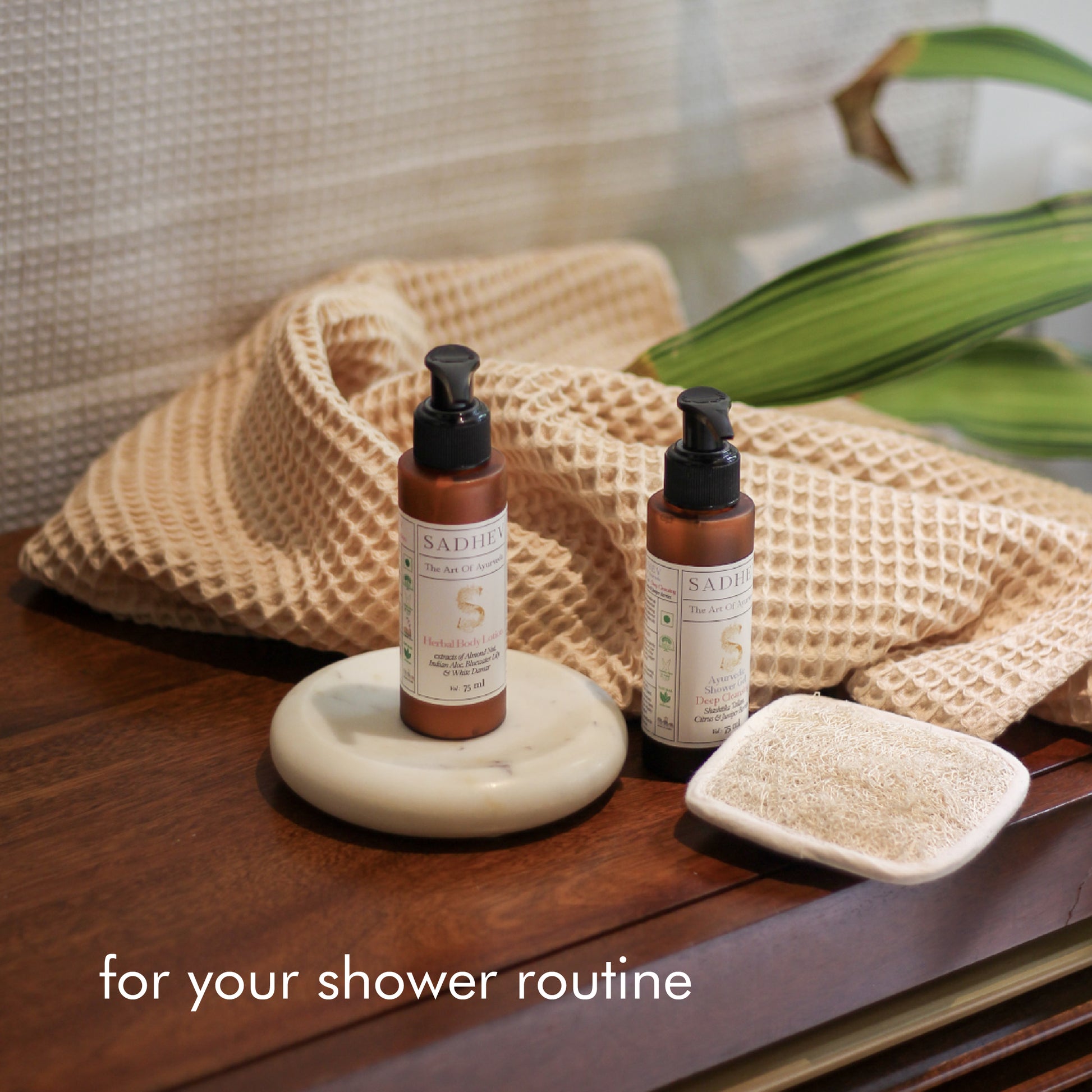 Soak & Soothe Bath Kit featuring Ayurvedic shower gel, body lotion, waffle luffa scrubber, latte waffle bath towel, cozy bath slippers, and a waffle storage basket.