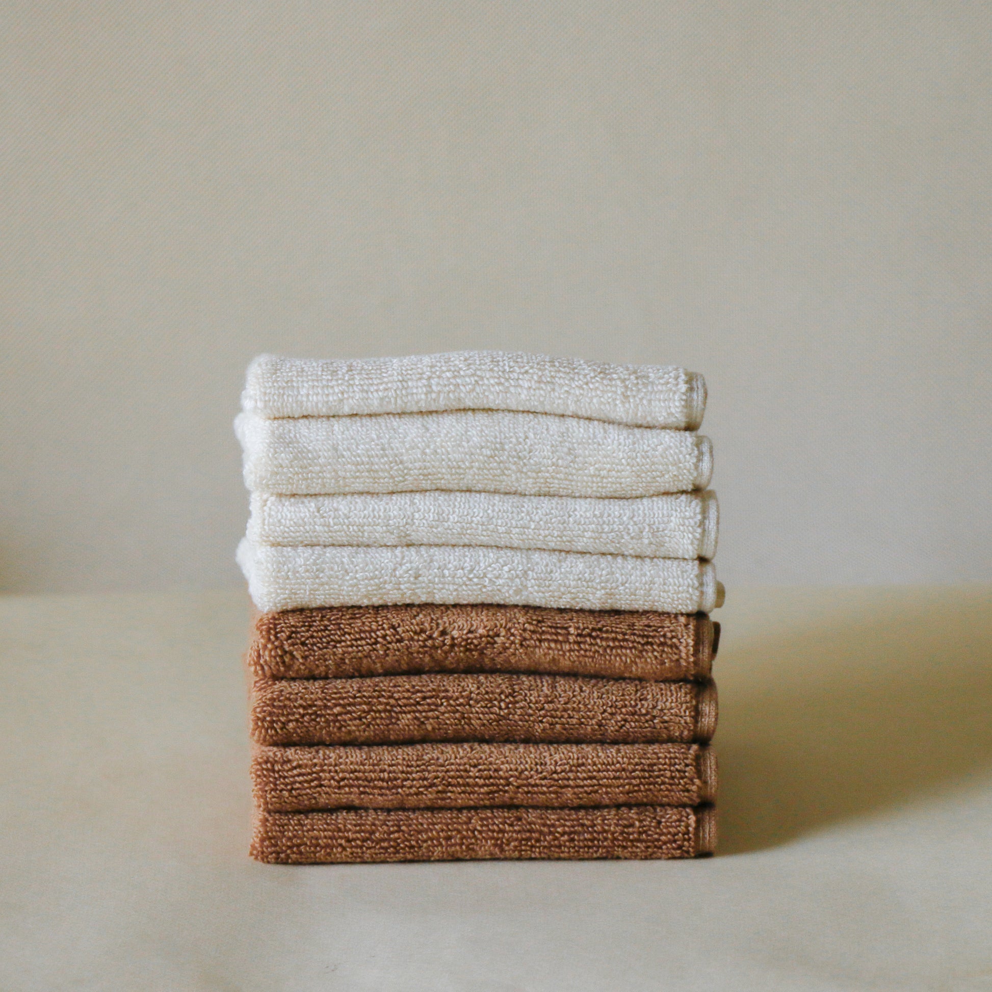 Pack of four soft terry cotton face towels with zero-twist texture, plush and highly absorbent.