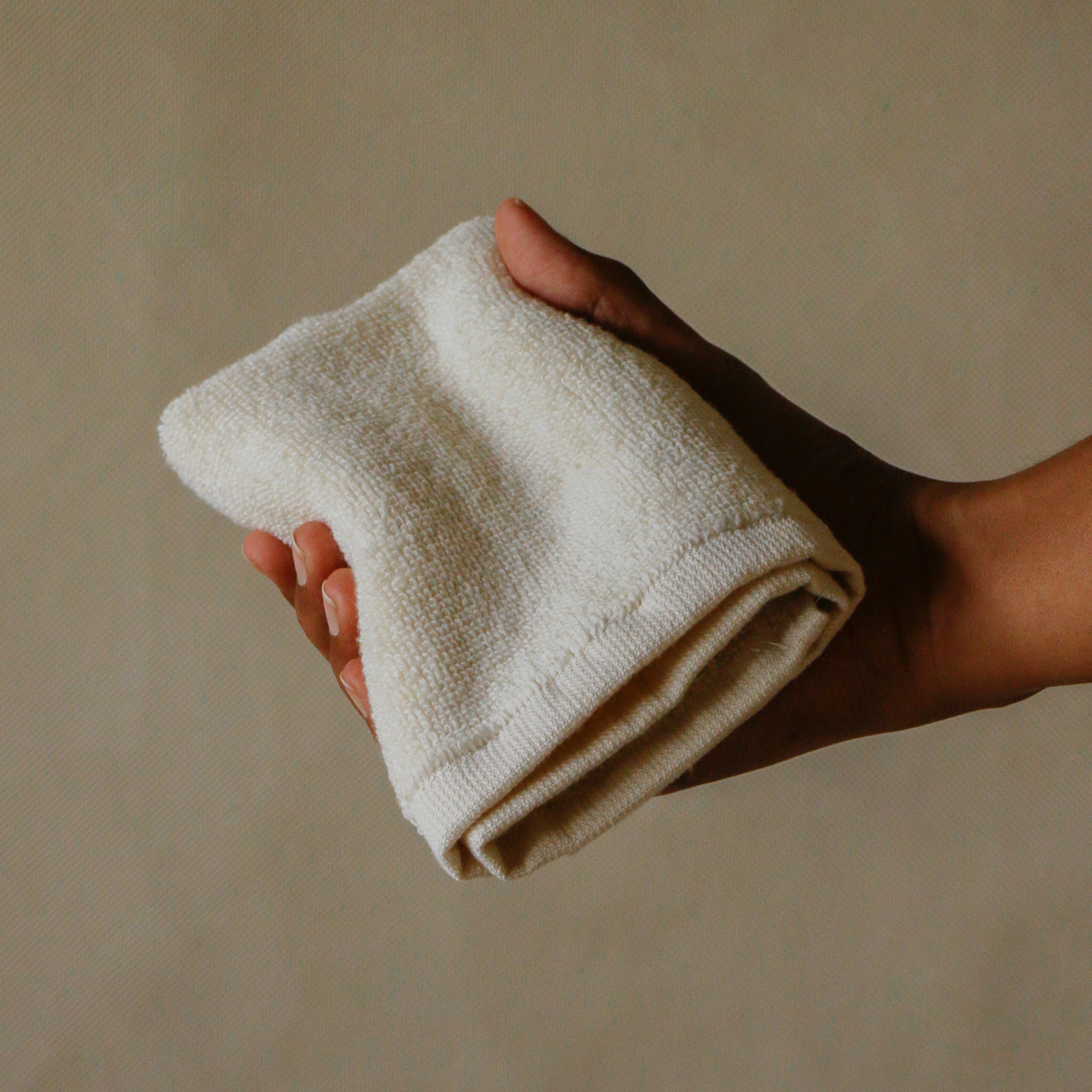 Pack of four soft terry cotton face towels with zero-twist texture, plush and highly absorbent.